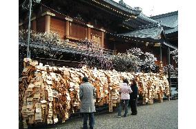 Votive tablets inscribed by university students adorn shrine