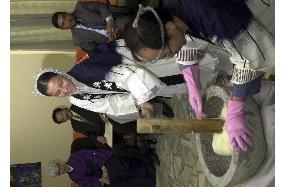 Afghans enoy making rice cake