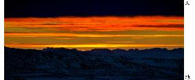 Setting sun paints Antarctic sky bright red