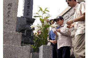 Iraqi boy visits graves of Japanese journalists who helped him