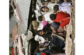 Women, children spend days in front of collapsed house