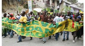 Supporters of Rene Preval march in Port-au-Prince
