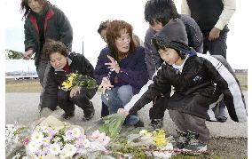 People offer flowers for victimized kindergartners