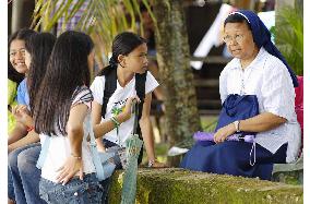 Orphans from Philippine landslide spend life in group