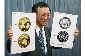 Tanigaki unveils two 50th anniversary coins