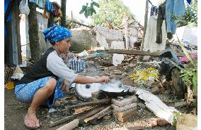 Woman cooks supper in Java