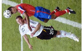 Podolski fighting for the ball