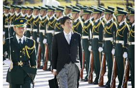 Abe reviews guard of honor at newly named Defense Ministry