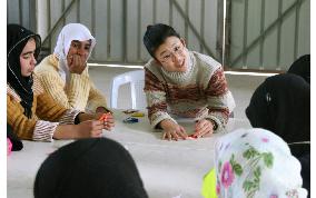 Japanese NGO worker teaches children origami in Gaza