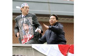 Korean protester climbs onto guard house roof at Japan Embassy