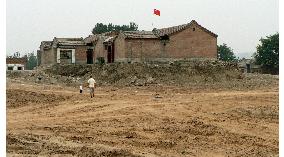 Beijing home-owners who refuse to sell land live in isolation