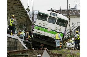 Derailed train car put back on railway tracks