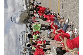 Children drag jumbo jet at Narita airport