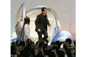 Ghosn with bubble-shaped Nissan concept car at Tokyo Motor Show