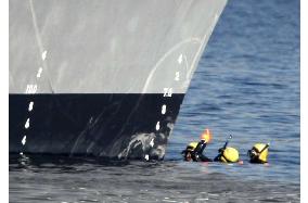 Coast Guard divers examine destroyer involved in collision