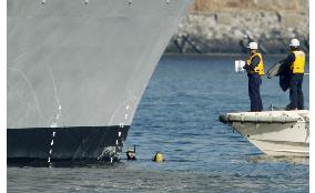 Coast Guard divers examine destroyer involved in collision