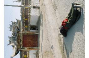 Tibetan prays at Tibetan monastery in Qinghai, China