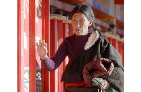 Tibetan prays at Tibetan monastery in Qinghai, China