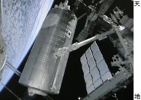 Shuttle crew install main component of Japanese laboratory unit