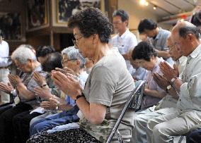 Evacuees offer silent prayer 1 month after powerful earthquake