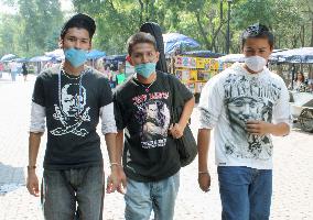 People wear masks following swine flu outbreak