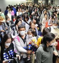 Travelers get quarantine checks at Narita airport