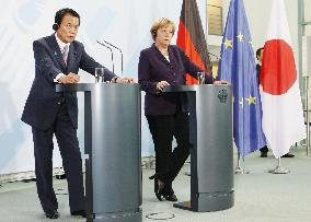 Aso, Merkel vow cooperation on financial crisis, new flu