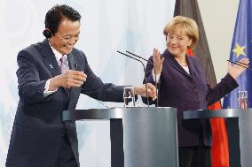 Aso, Merkel vow cooperation on financial crisis, new flu