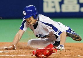 Chunichi pitcher Asao slides into home