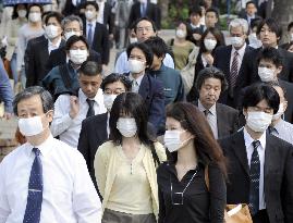 Employees head to offices wearing masks as flu spreads
