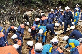 Rescue workers search for people missing in fatal mudslide