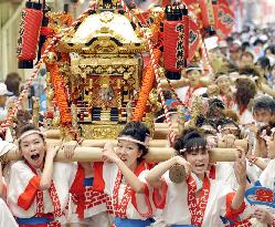 Women carry portable shrine at Osaka Tenjin Festival