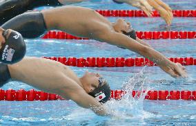 Koga wins gold in 100m backstroke