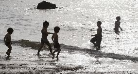 Children play at Akune seashore