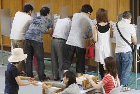 Voters cast votes at polling station