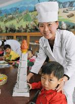 Child makes model of Juche Tower
