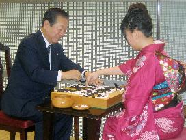 Ozawa plays go with woman champion