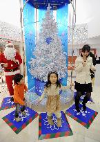 Children light up eco-friendly Christmas tree