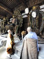 Monks dust Buddhist statues at Toshodaiji