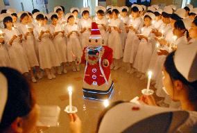 Nursing students sing Christmas songs with robot Santa conducting