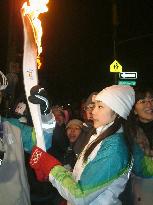 Figure skater Kim carries Olympic torch