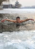 Swimming in icy Beijing pond