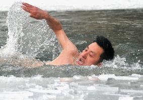 Swimming in icy Beijing pond