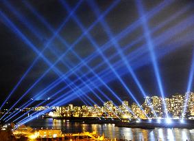 Laser beams illuminate night sky in downtown Vancouver