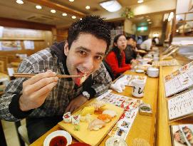 Tourist enjoys Tokyo tuna sushi