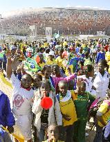 Children cheer near Soccer City