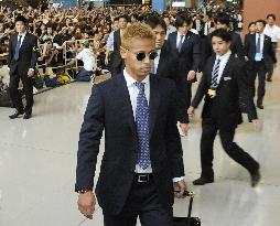 Japan's World Cup squad return home from South Africa