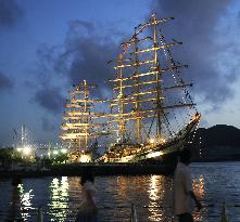 Sail ships lit up in Nagasaki harbor