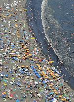 Crowded beach in sizzling Japan
