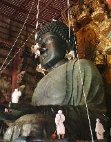 Monks clean massive Buddha statue in Nara